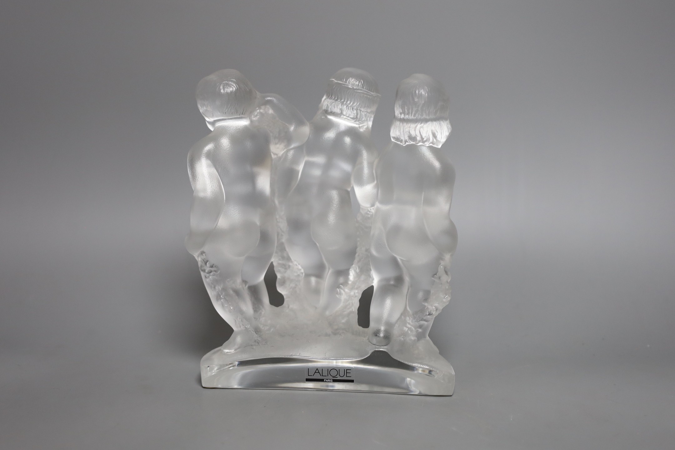 A Lalique glass model of three putti, boxed, 18 cms wide